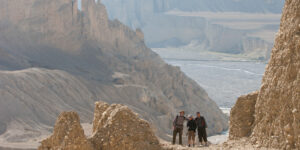 Trekkers on the descent to the Mustang river on the way to Dhi in the Mustang region of Nepal