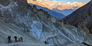 Mountain bikers pushing the bikes up the last bit of trail to Tilicho BC on the Annapurna Circuit