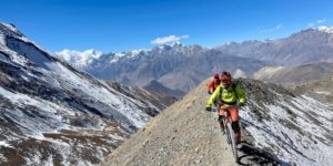 Riders coming down from the Thorung La pass into the Mustang valley on the Annapurna circuit