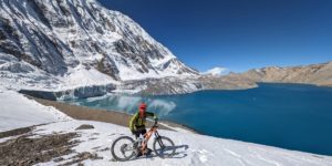 Mountain biker at Tilicho Lake on the Annapurna circuit in Nepal