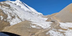 Trekkers approaching Dharmasala, just below the Thorung La pass on the Annapurna circuit