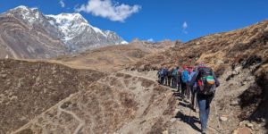 Trekkers climbing to Ice Lake (Khicho Tal) above Braga in the Manang valley on the Annapurna circuit
